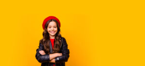 young girl smiling with arms crossed