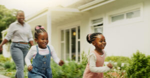 happy, healthy children running outside with mom following