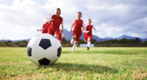 Kids soccer team headed to kick the ball
