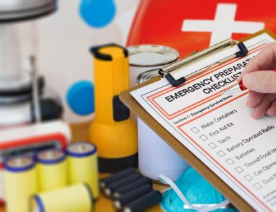 Hand completing Emergency Preparation List by Equipment